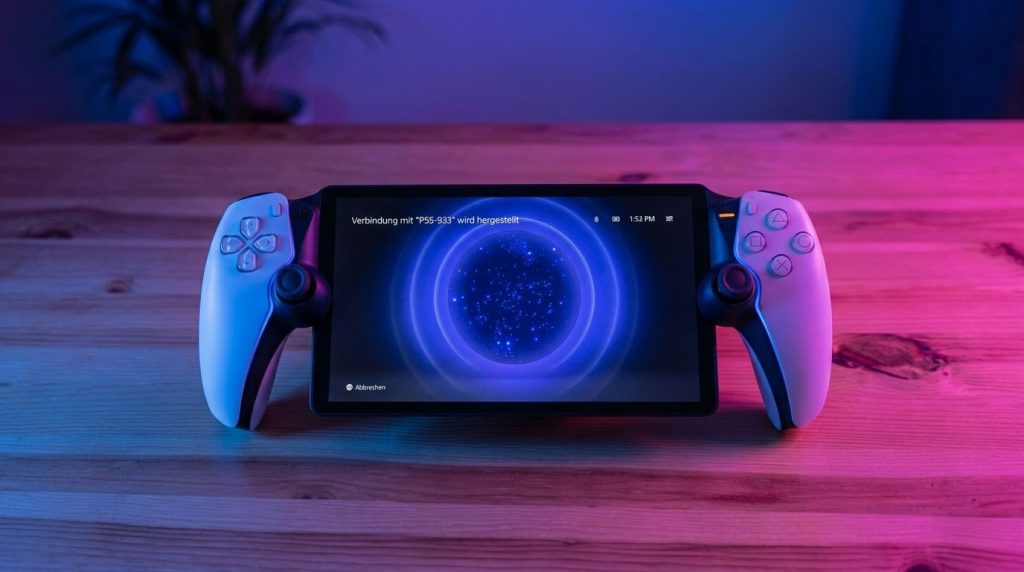Ein Gaming-Handheld mit einem Bildschirm, auf dem eine Verbindungsmeldung angezeigt wird, liegt auf einem Tisch. An beiden Seiten sind Gamecontroller angebracht. Das Setup ist in blau-rosa Licht getaucht.